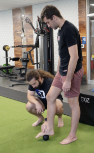 Rene loosening up the connective tissue to improve his arches for BJJ